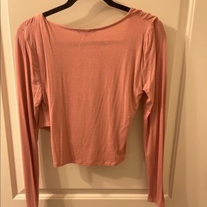 Soft sweater with crisscrossed front.